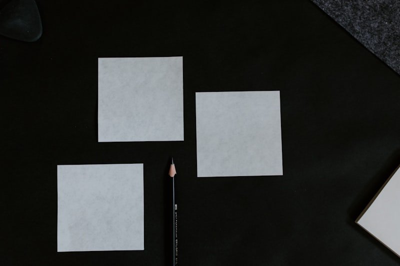 A black table topped with a pencil and paper